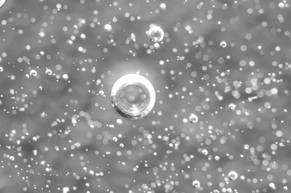 Air bubbles in a liquid. Abstract black-and-white background. Ma