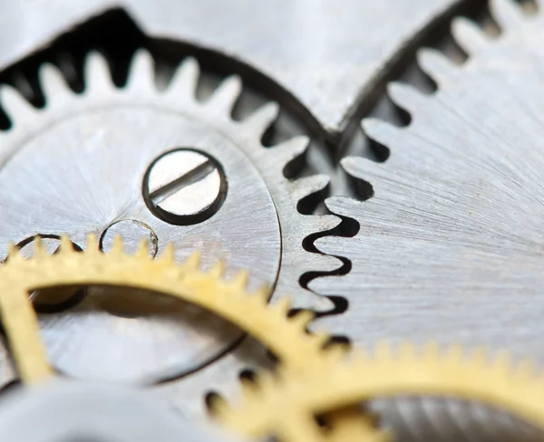 Fondo metálico con ruedas dentadas de metal un reloj. Macro — Foto de Stock