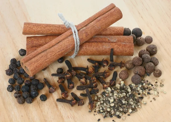 A set of spices on wooden cutting board close up — Stock Photo, Image