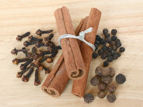 A set of spices close up on a wooden cutting board. — Stock Photo, Image