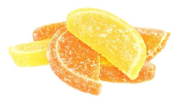 Eine Handvoll orangefarbene und gelbe Bonbons — Stockfoto