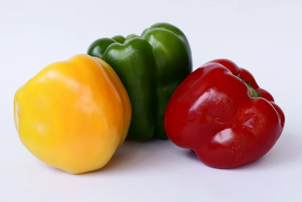 Red,green and yellow bell peppers on white background — Stock Photo, Image