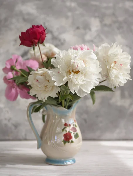 Stilleven met witte en roze pioenrozen in een witte vaas — Stockfoto