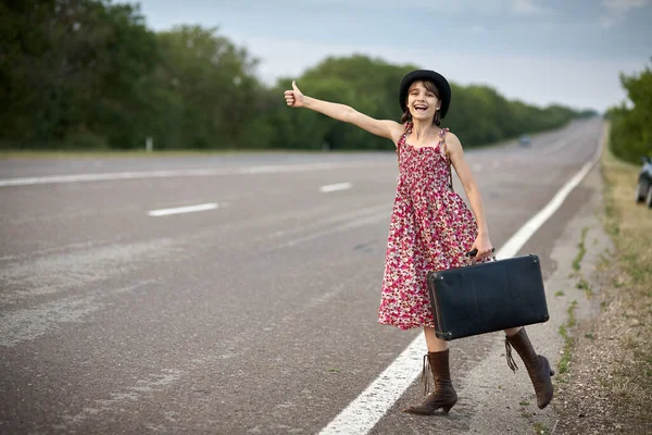 Girl on the road with old case stoped auto