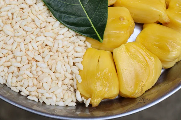 tasty and healthy jackfruit cloves with leaf and puffed rice on plate