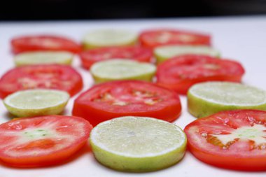 tasty and healthy sliced tomato and lemon stock on kitchen for eat