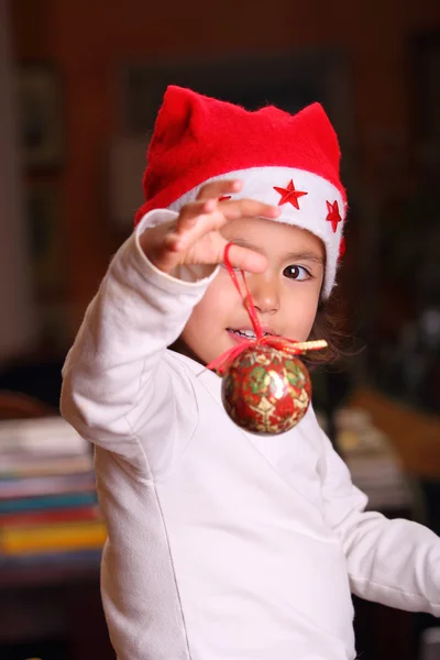 Child plays with Christmas decorations — Stock Photo, Image