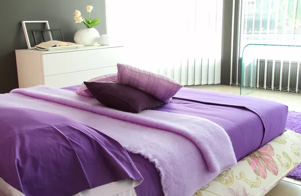 Purple bedroom in morning light Stock Picture