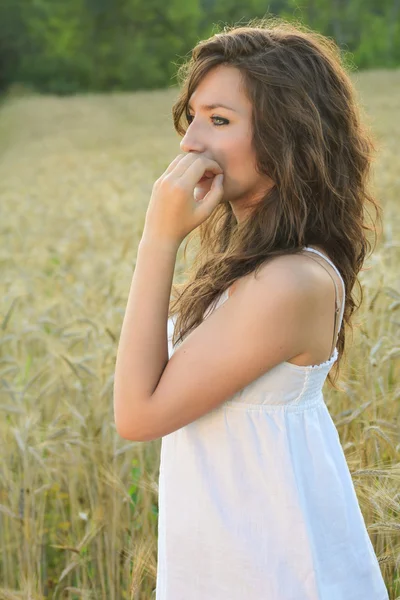 Retrato de una hermosa niña en un campo de trigo —  Fotos de Stock