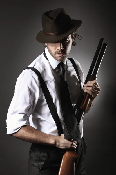 Beau gangster posant avec fusil de chasse et chapeau — Photo