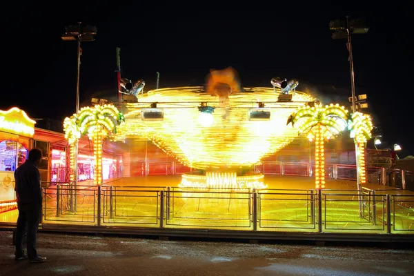 Fast carousel with colorful lights — Stock Photo, Image