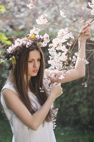 Portrait of a beautiful girl among cherry flowers. Spring and romance concept