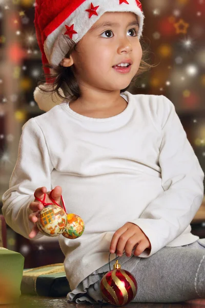 Little child playing happy with Christmas decorations — Stock Photo, Image