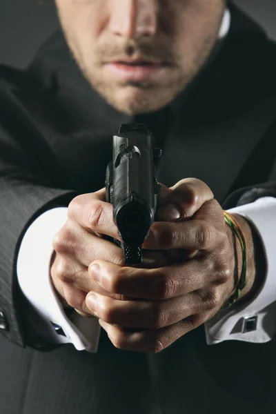 Detail of hands holding a gun — Stock Photo, Image