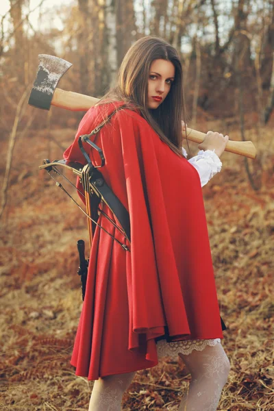 Dangerous Little red riding hood with axe — Stock Photo, Image