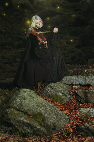 Dark portrait of a vampire with violin. Fantasy and halloween concept