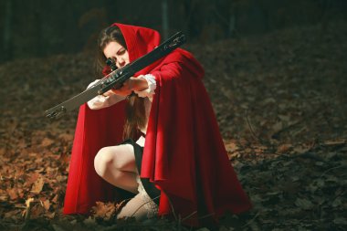 Little red riding hood aiming with crossbow clipart