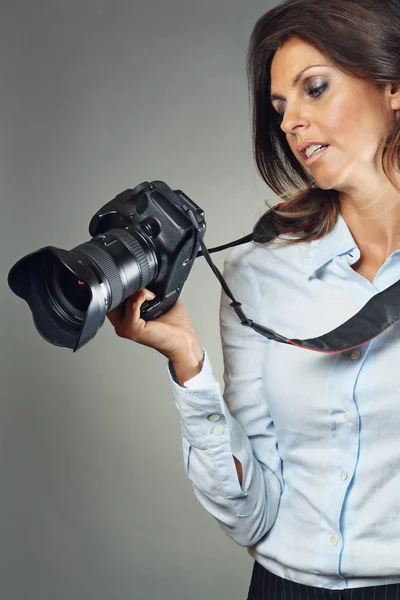 Photographer checking display of the camera — Stock Photo, Image