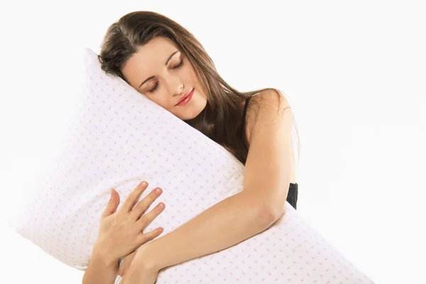 Beautiful girl embraces her pillow — Stock Photo, Image