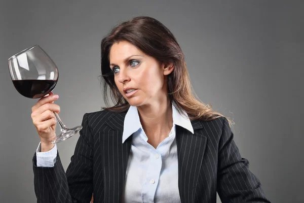 Beautiful woman looking at wineglass — Stock Photo, Image