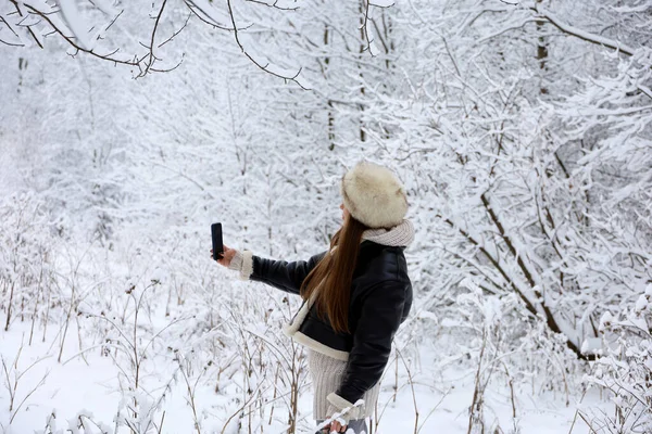 Girl Black Coat Fur Hat Taking Selfie Smartphone Camera Background — 图库照片