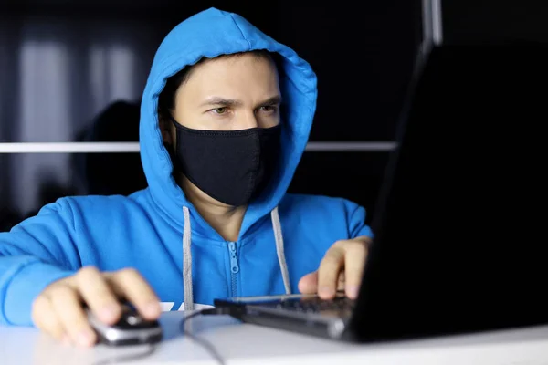 Man Mask Blue Hoodie Sitting Laptop Concept Safety Office Work — Zdjęcie stockowe