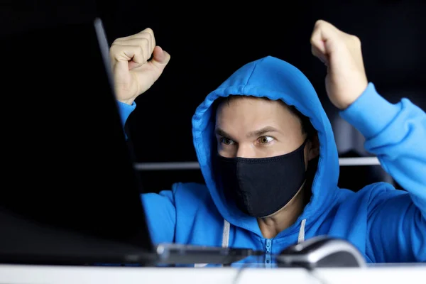 Joy Surprise Man Black Mask Blue Hoodie Sitting Laptop His —  Fotos de Stock