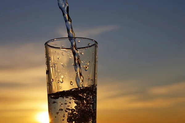Clean Water Pouring Drinking Glass Sunset Sky Background Concept Health — Stock Photo, Image
