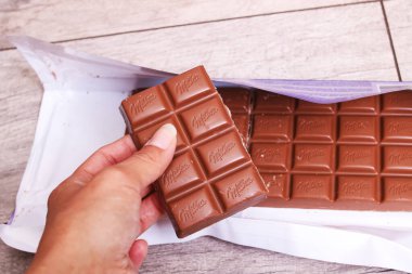BELARUS, NOVOPOLOTSK - 20 EKİM, 2021: Büyük Milka çikolatası ahşap bir masada