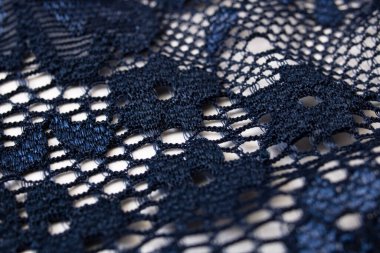 Mavi kumaşta dantelli çiçekler. Yaklaş.