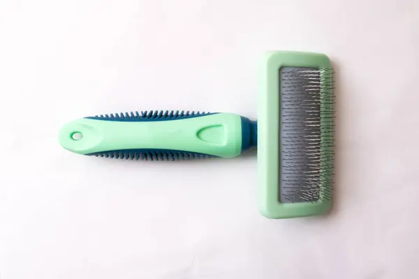 Green animal comb on white background close p — Photo