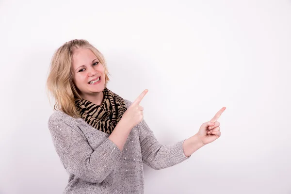 Young woman pointing on white background — Stock Photo, Image