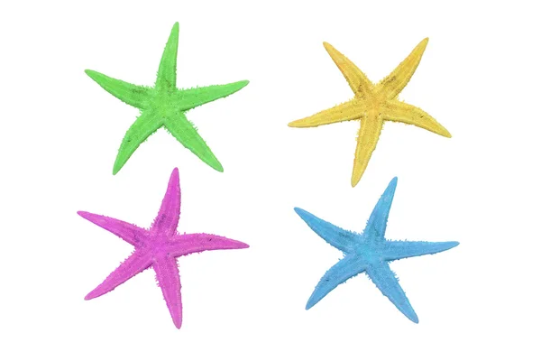 Четыре разноцветные морские звезды на белом фоне — стоковое фото
