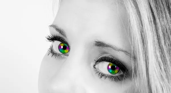 Beautiful woman with rainbow colored eyes — Stock Photo, Image