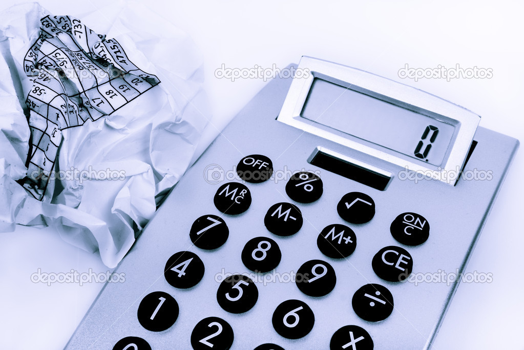 calculator and a crumpled paper on the side