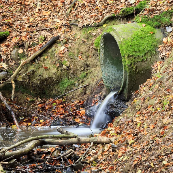 Water pouring from a drain pipe — Stock Photo, Image