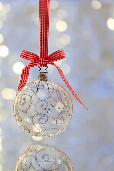 Bola de Navidad transparente colgada en cinta roja — Foto de Stock