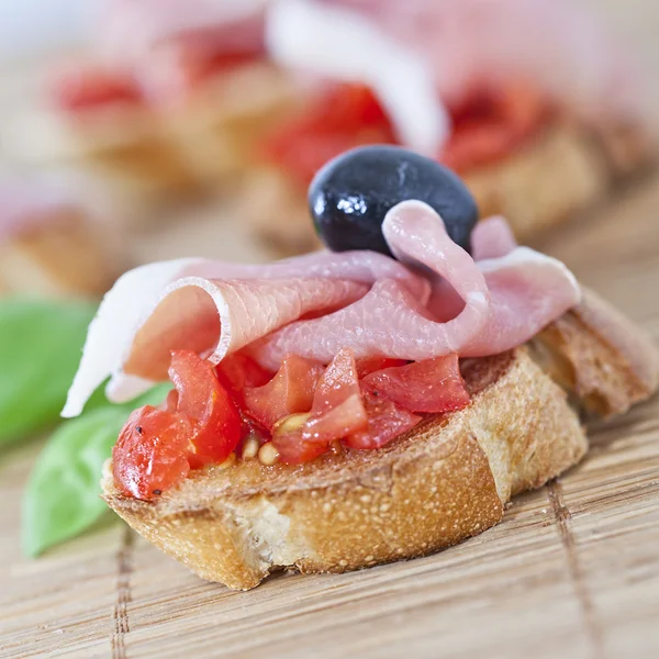 Slices of bread with spanish serrano ham — Stock Photo, Image