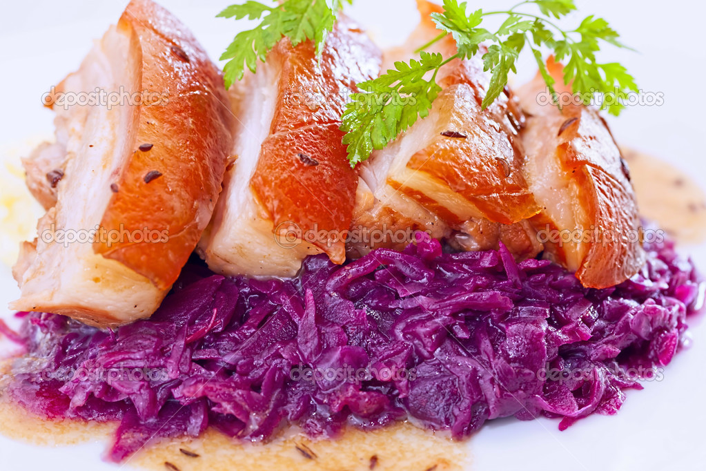 Sliced baked pork belly with fresh boiled red cabbage