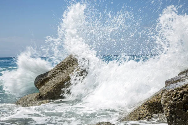 High wave breaking on the rocks of the coastline. Stock Photo