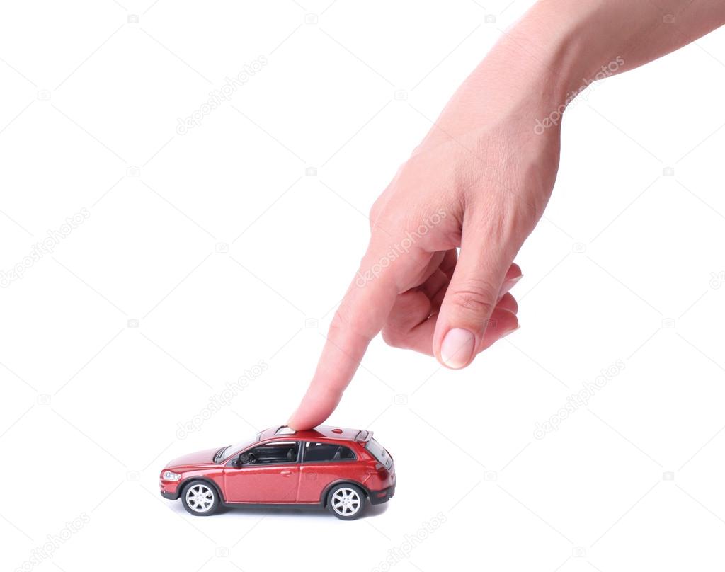 Female hand and the toy car