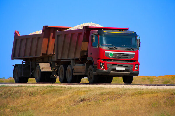 Red dump truck with the trailer