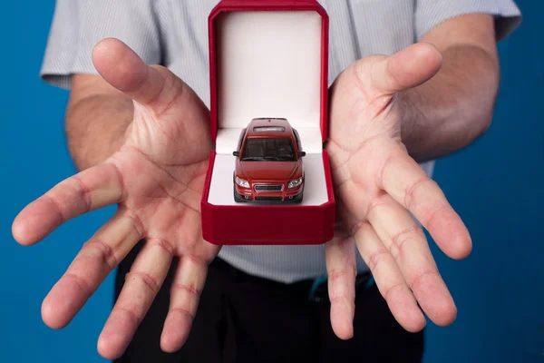 Box with car in mans hands — Stock Photo, Image