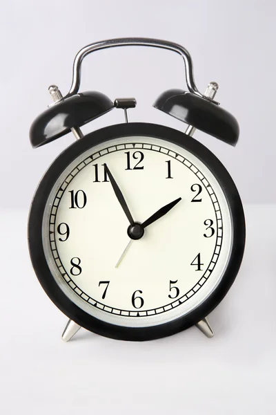 Black mechanical clock on white background — Stock Photo, Image