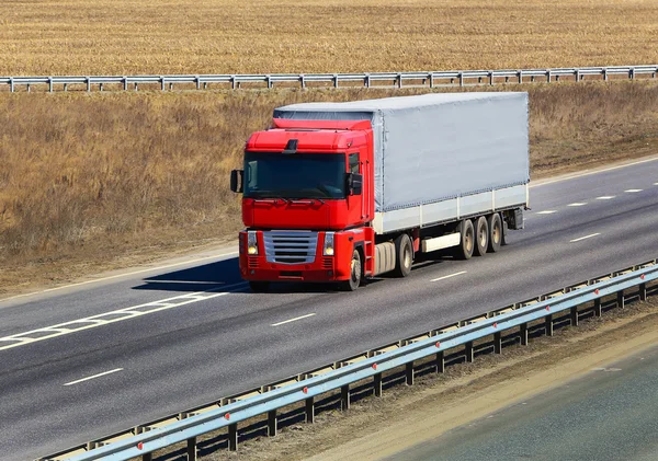 Trailer with red awning moves on the highway — Stock Photo, Image