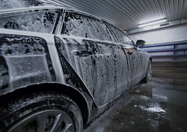 Black car in foam on sink — Stock Photo, Image