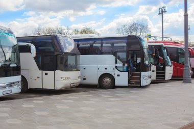 Bulutlu gökyüzünün arka planında turist otobüsleri