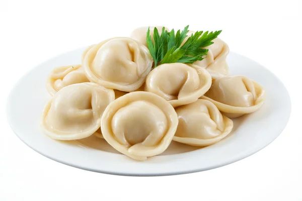 Dumplings och persilja - ryska pelmeni - italienska ravioli - på w Royaltyfria Stockfoton