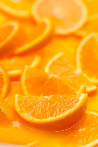 Orange slices in juice — Stock Photo, Image