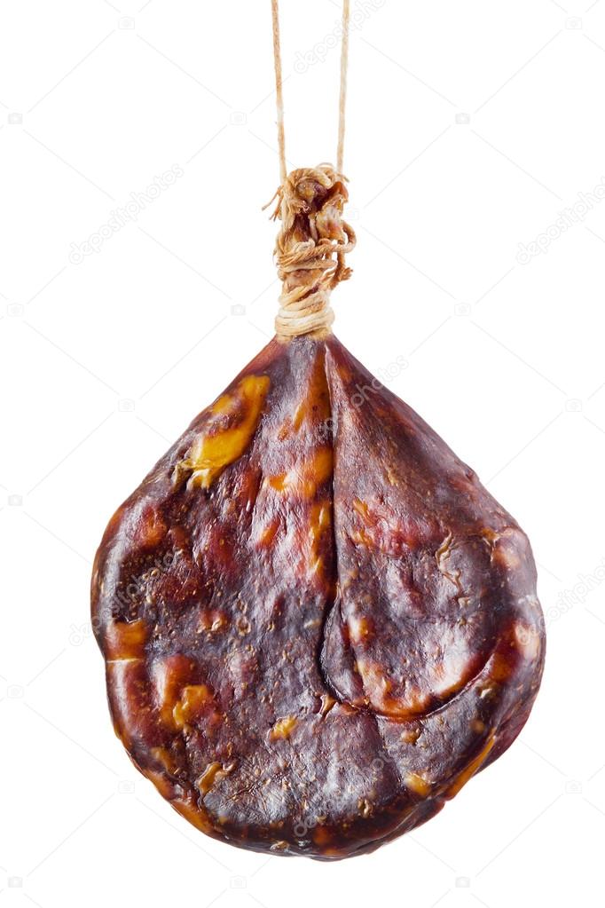 Dry sausage is hanging on hook isolated on white